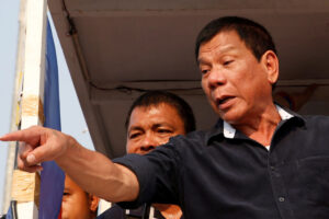 FILE PHOTO: Presidential candidate Rodrigo "Digong" Duterte greets supporters during election campaigning in Malabon, Metro Manila